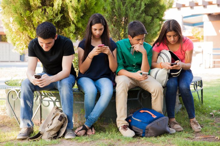 Teenagers with smartphones